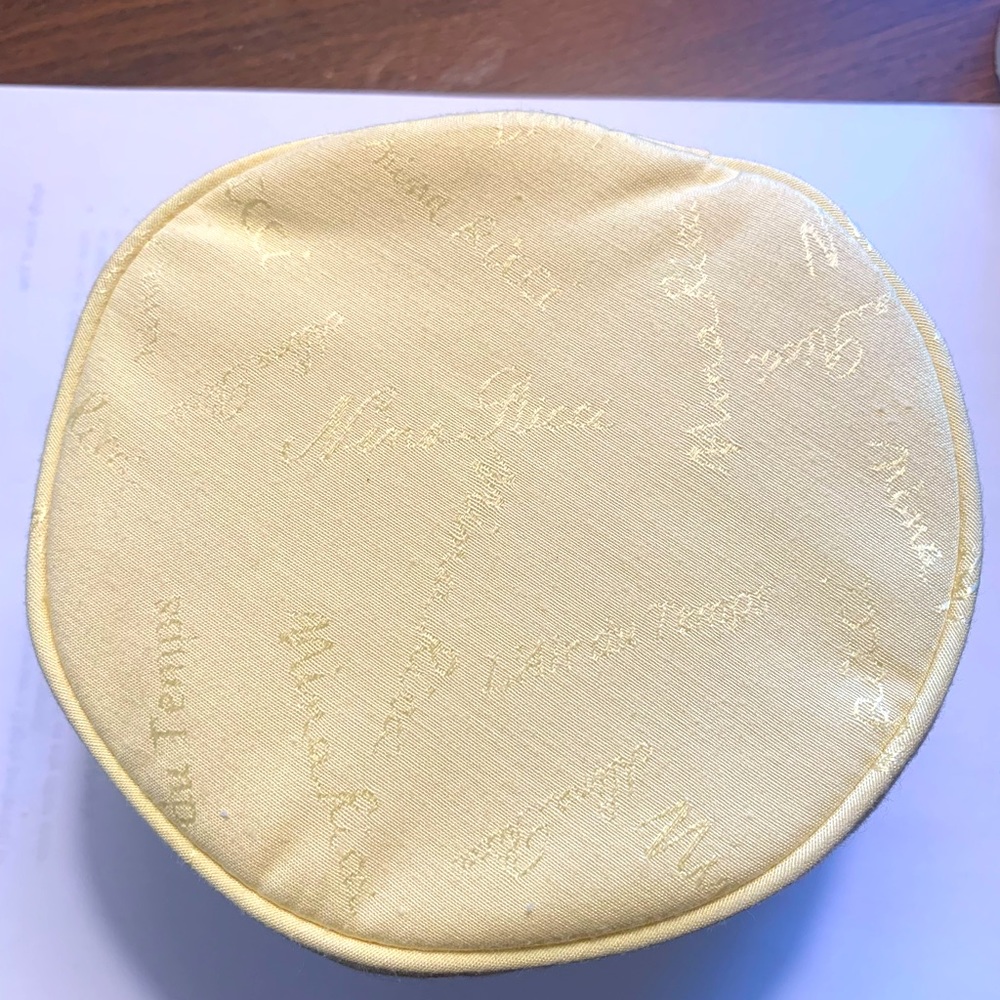 Mint yellow fabric Nina Ricci jewelry travel bag.
